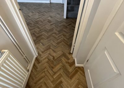 Camaro Cambridge Oak flooring fitted to the lounge and hall and Cormar Primo Natural Midnight Grove carpeting fitted to the stairs and landing - Flitwick MK45